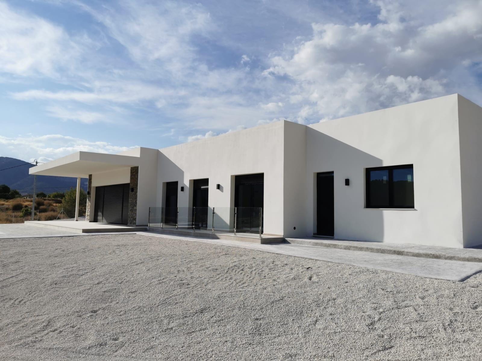 Custom-Built-New-Villas-in-Pinoso-Alicante-Spacious-Homes-in-Natural-Surroundings-8 Rear elevation and gravel driveway of a country villa in Pinoso, Alicante