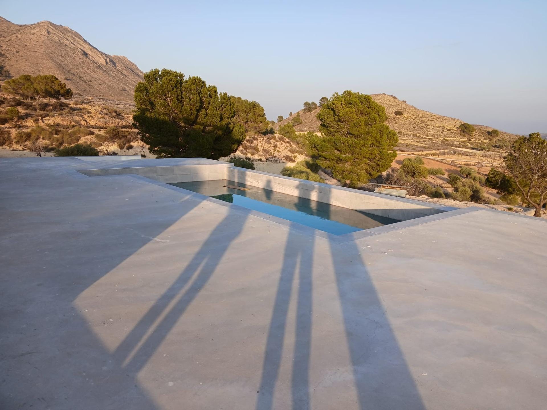 Custom-Built-New-Villas-in-Pinoso-Alicante-Spacious-Homes-in-Natural-Surroundings-8 Private pool and paved terrace with surrounding hills in Pinoso, Alicante