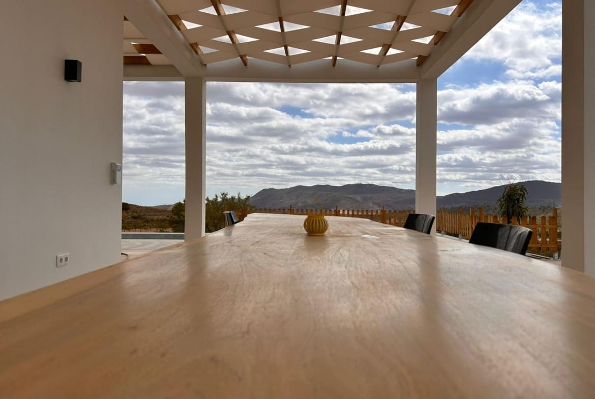 Outdoor dining table beneath a shaded villa terrace in Pinoso, Alicante