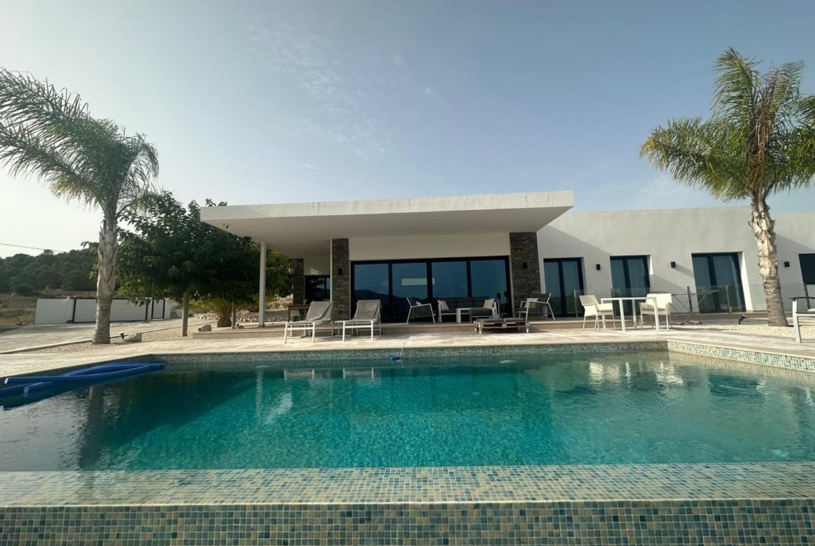 Private pool and shaded terrace beside a villa in Pinoso, Alicante