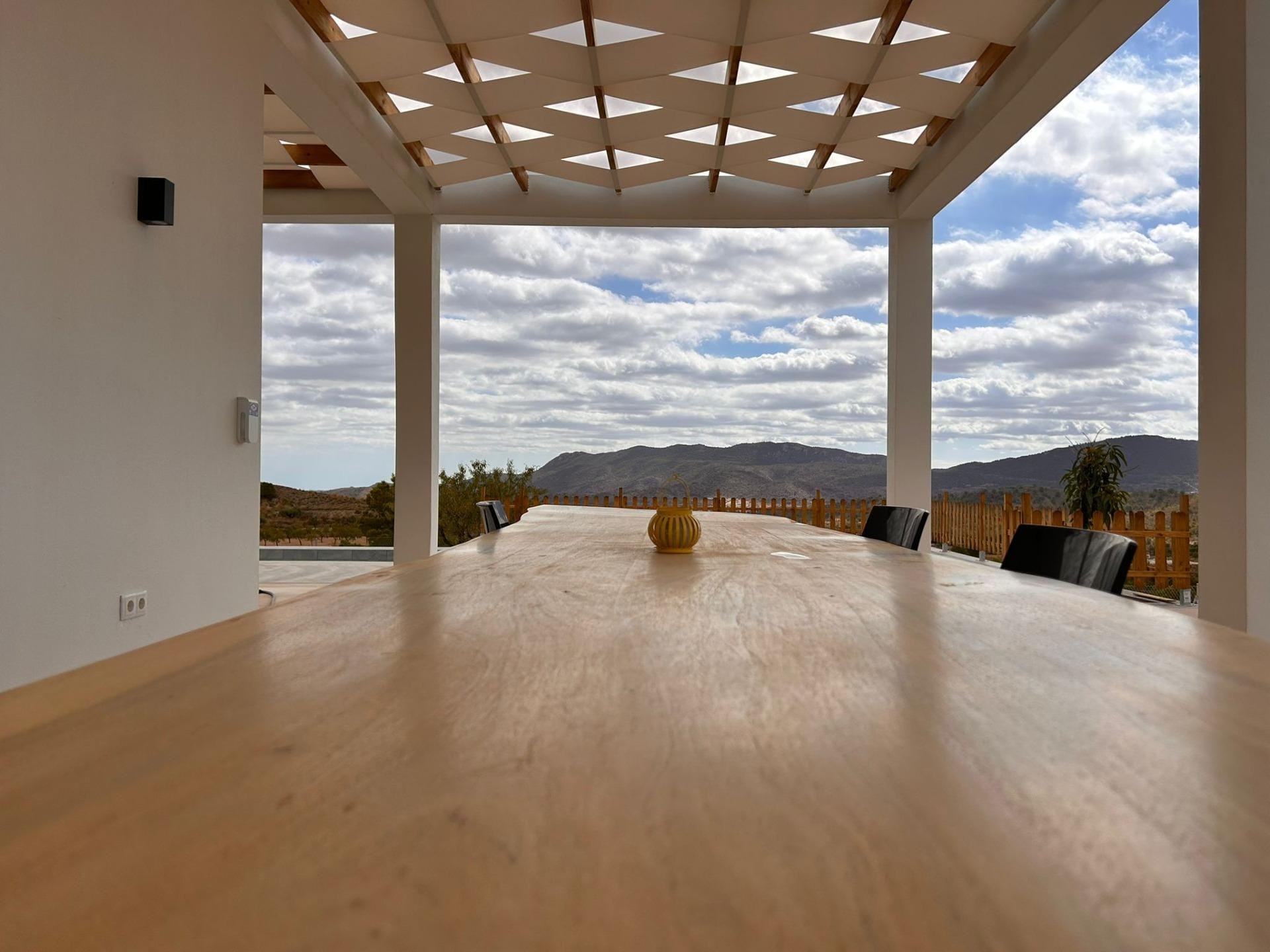 Custom-Built-New-Villas-in-Pinoso-Alicante-Spacious-Homes-in-Natural-Surroundings-9 Outdoor dining table beneath a shaded villa terrace in Pinoso, Alicante