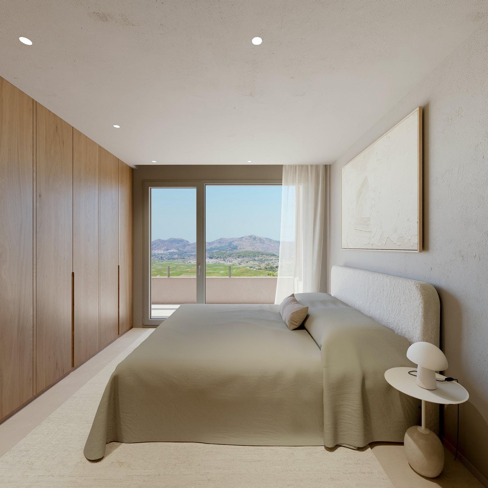 Double bedroom with fitted wardrobes and mountain-view terrace