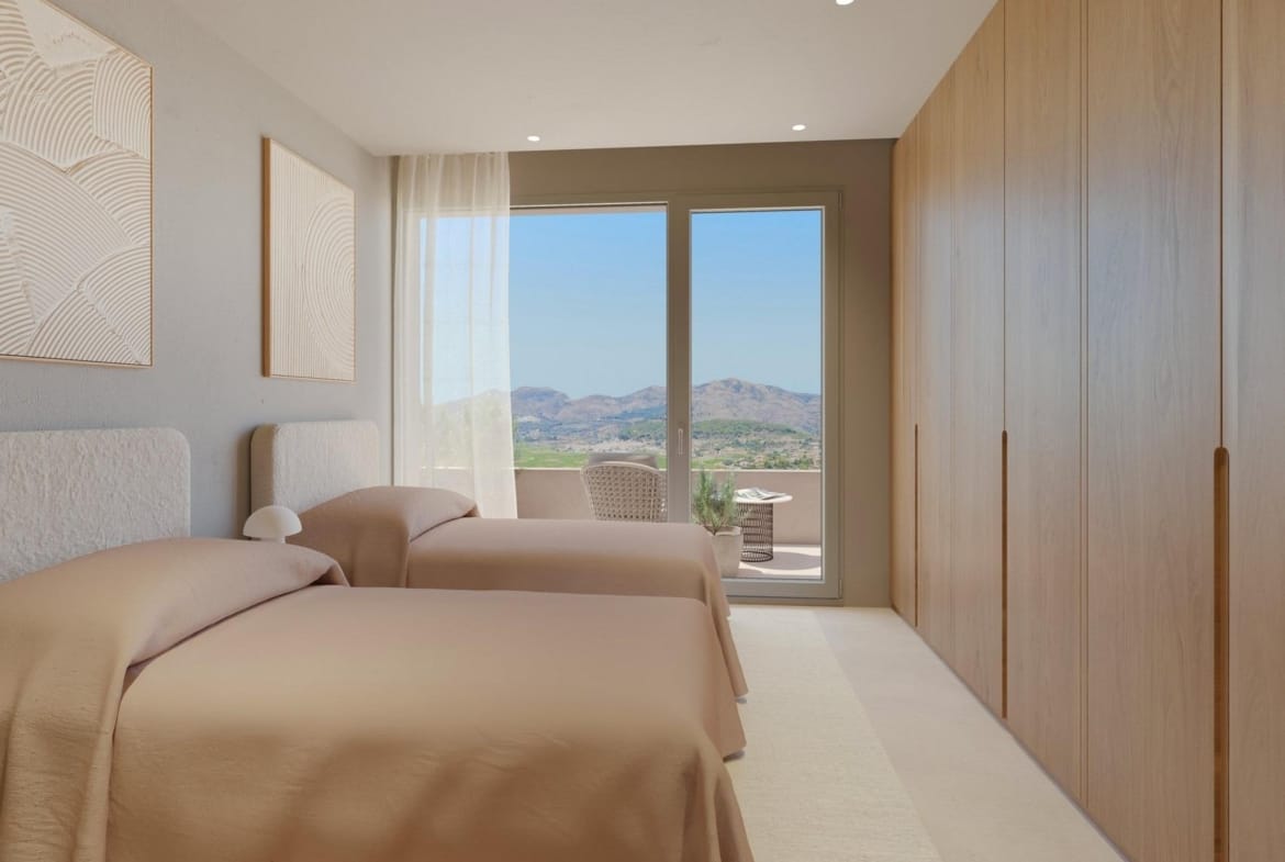 Twin bedroom with fitted wardrobes and private balcony