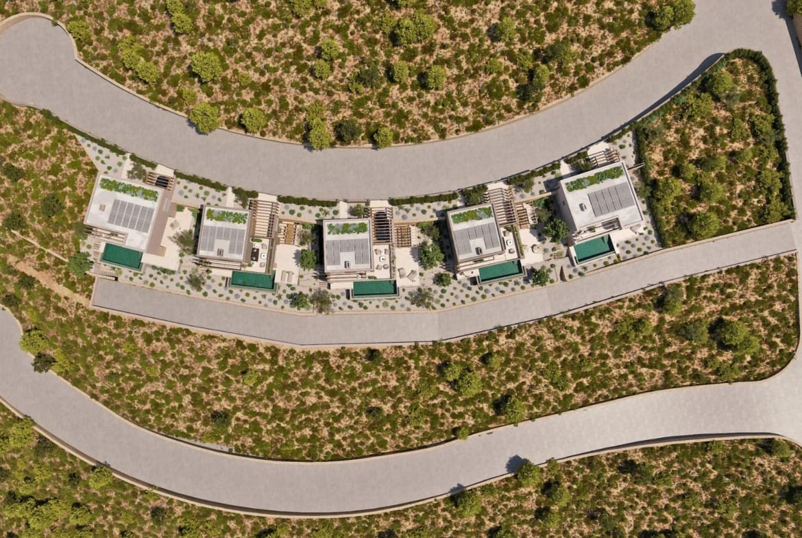 Aerial site view showing villa plots, private pools and access road
