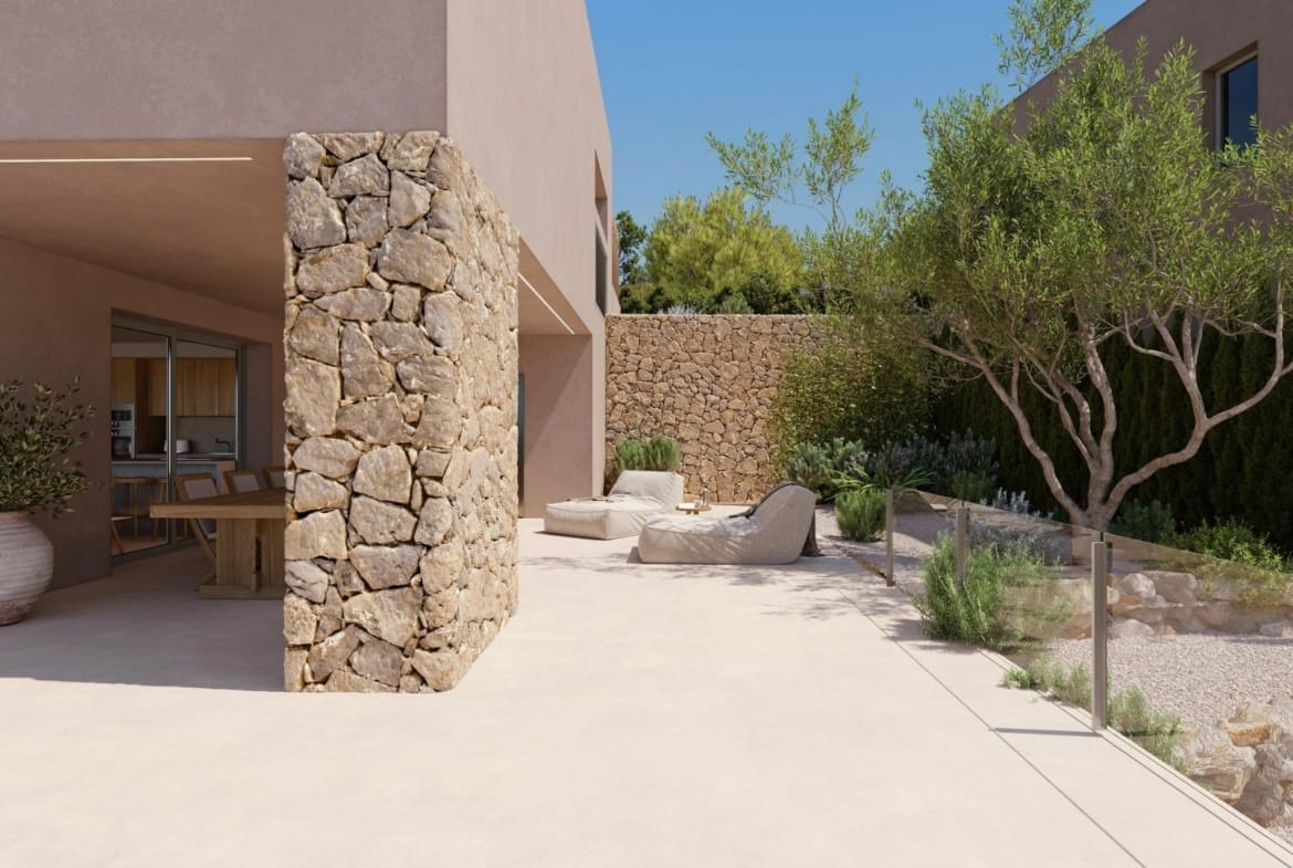 Side terrace with natural stone wall and Mediterranean landscaping