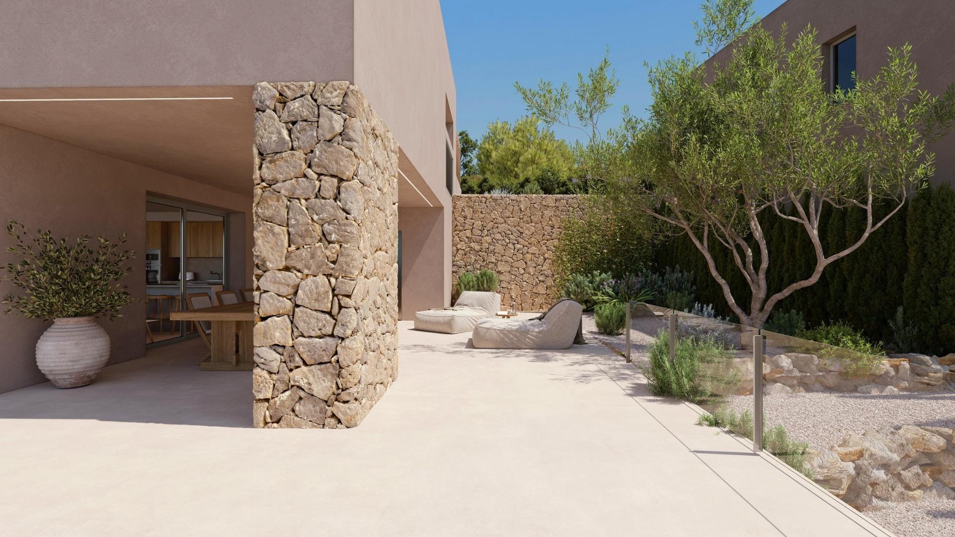 Side terrace with natural stone wall and Mediterranean landscaping