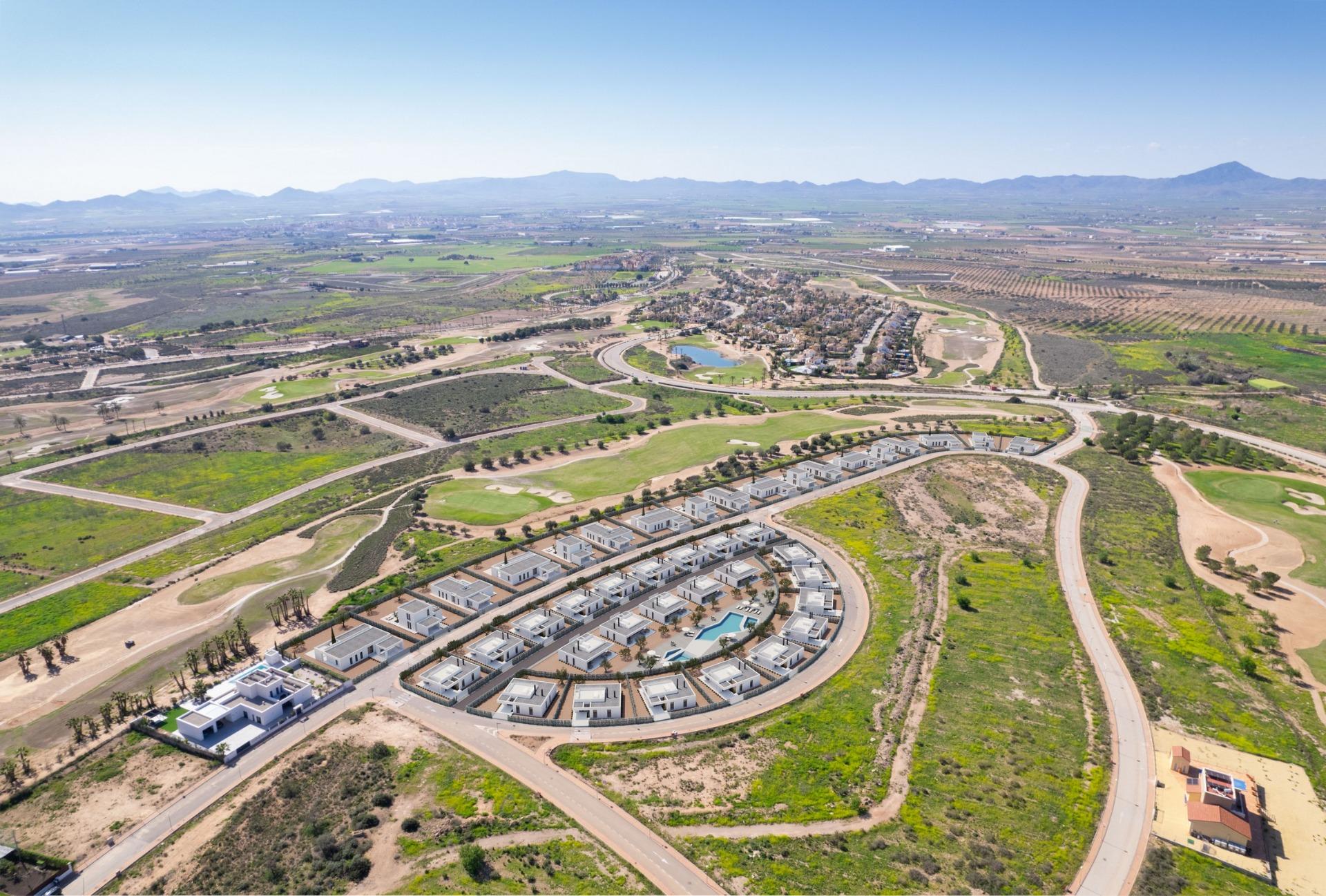 Aerial panorama showing new villa plots beside fairways and surrounding countryside