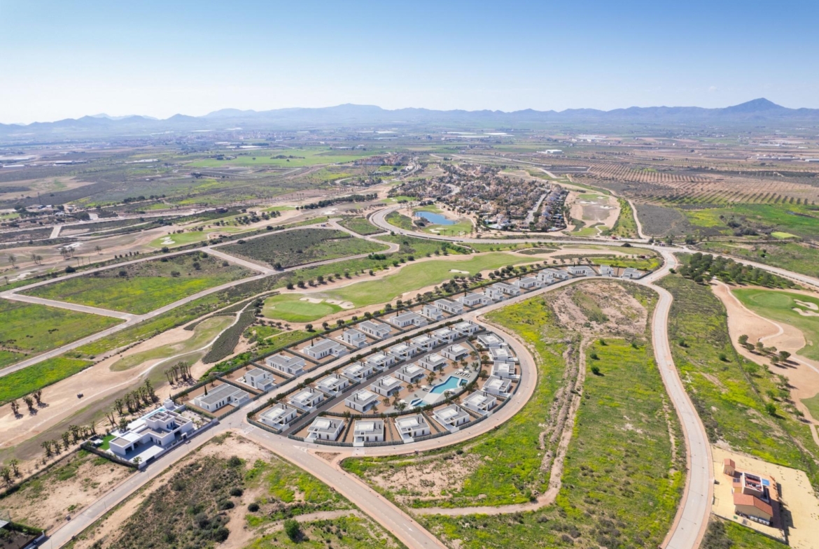 Aerial view showing new villa plots, roads and surrounding golf course landscape