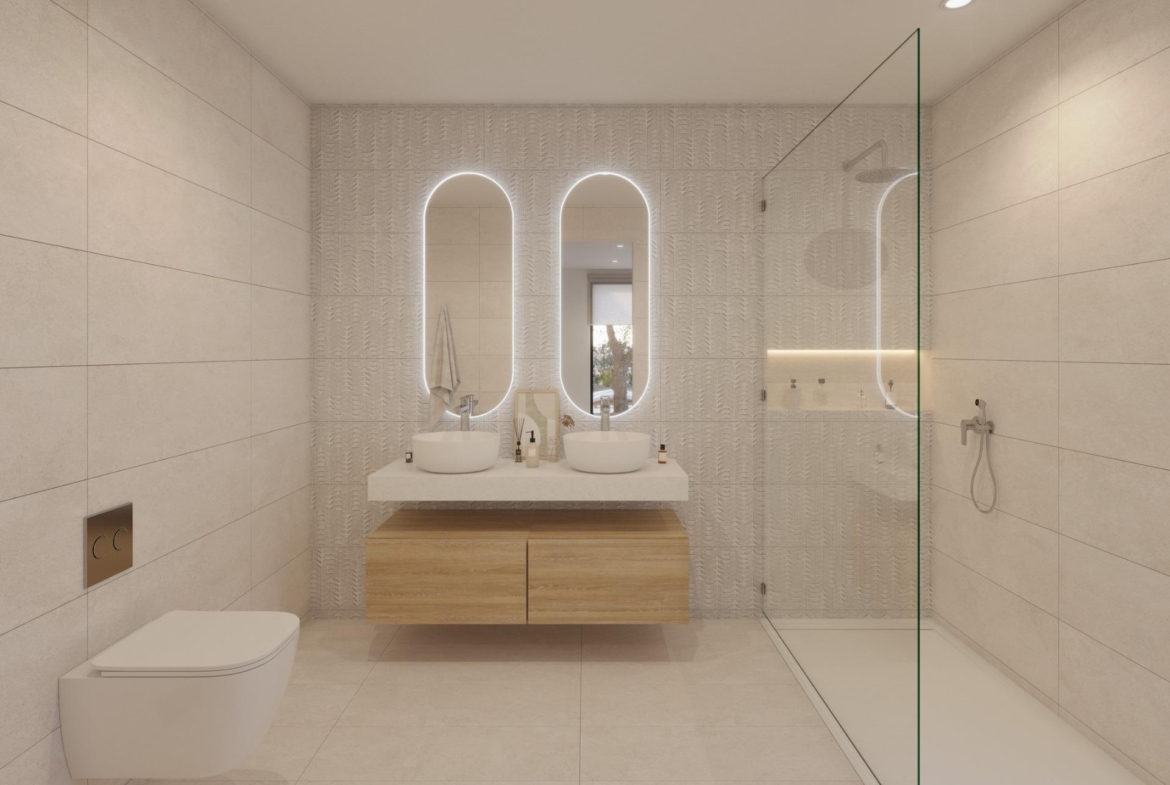Bathroom with twin vessel basins, two illuminated mirrors and glass walk-in shower