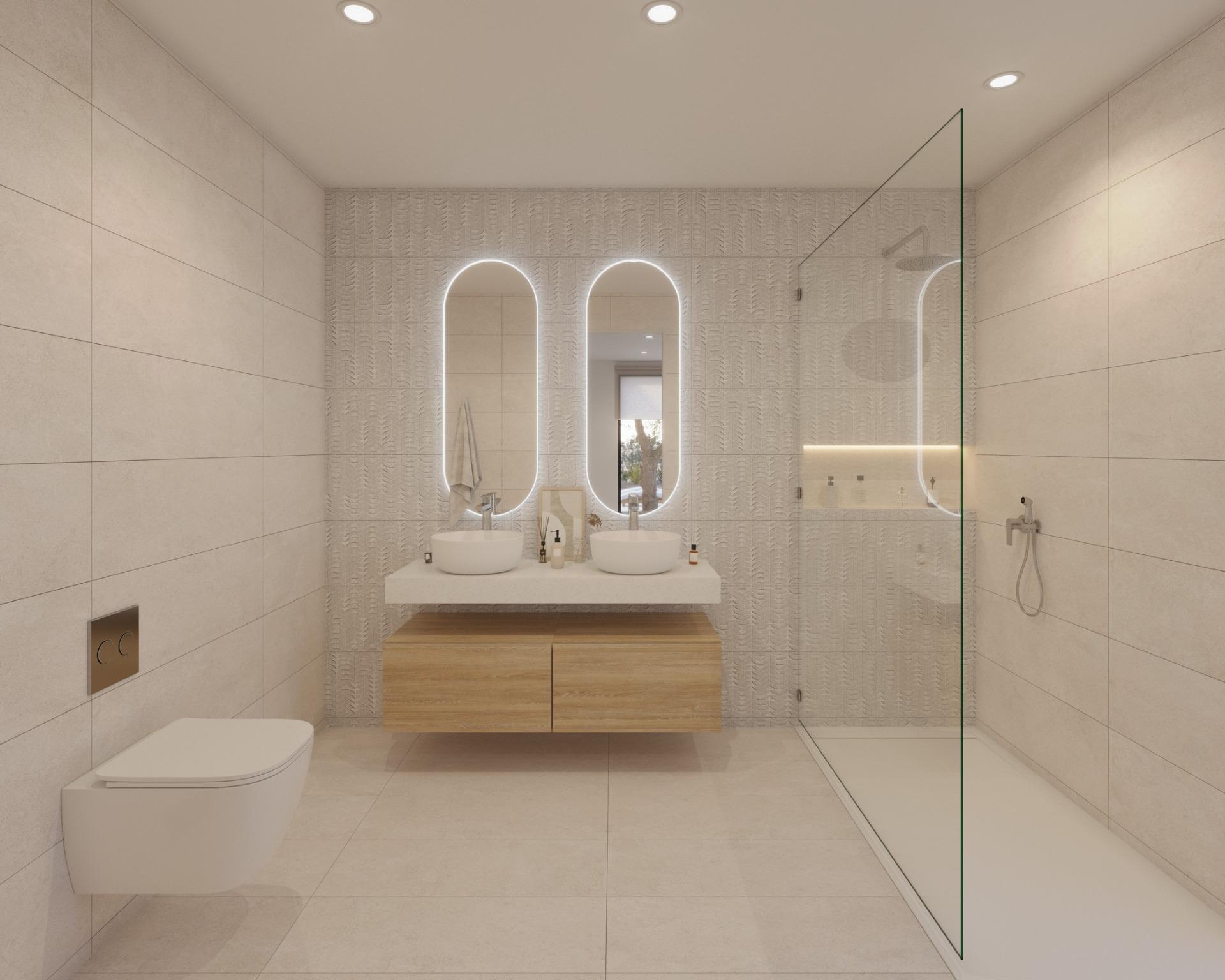 Bathroom with twin vessel basins, two illuminated mirrors and glass walk-in shower