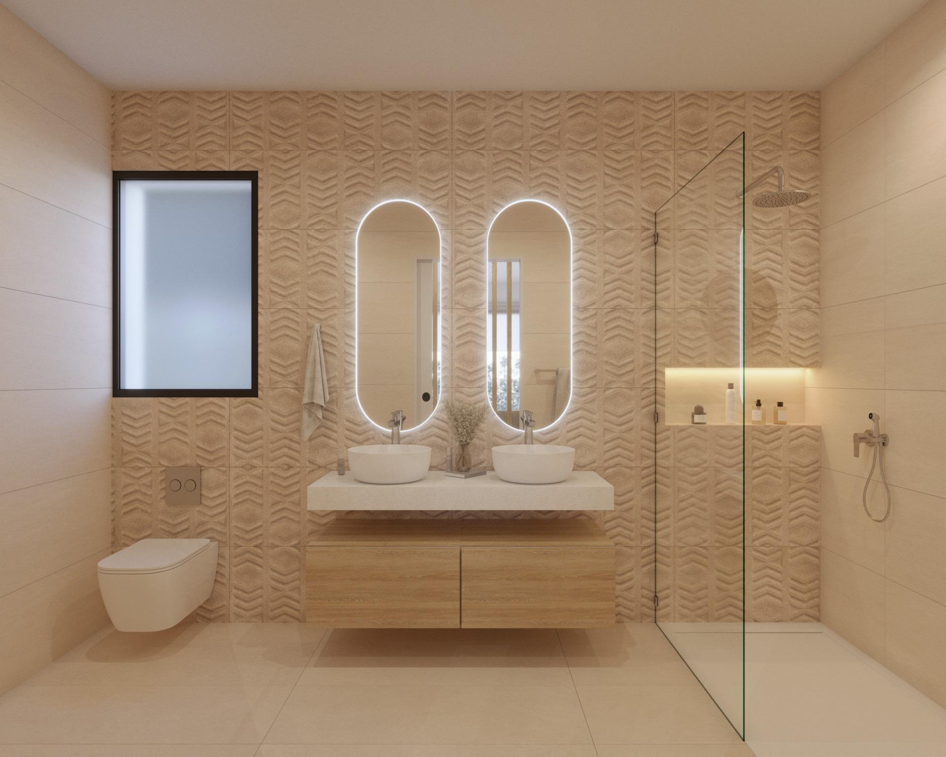 Bathroom with circular illuminated mirror, single basin and patterned tile wall