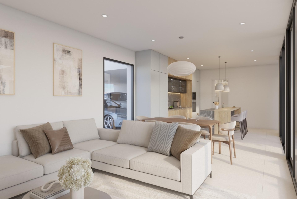 Neutral-toned living room view with wall-mounted TV, shelving and dining table behind