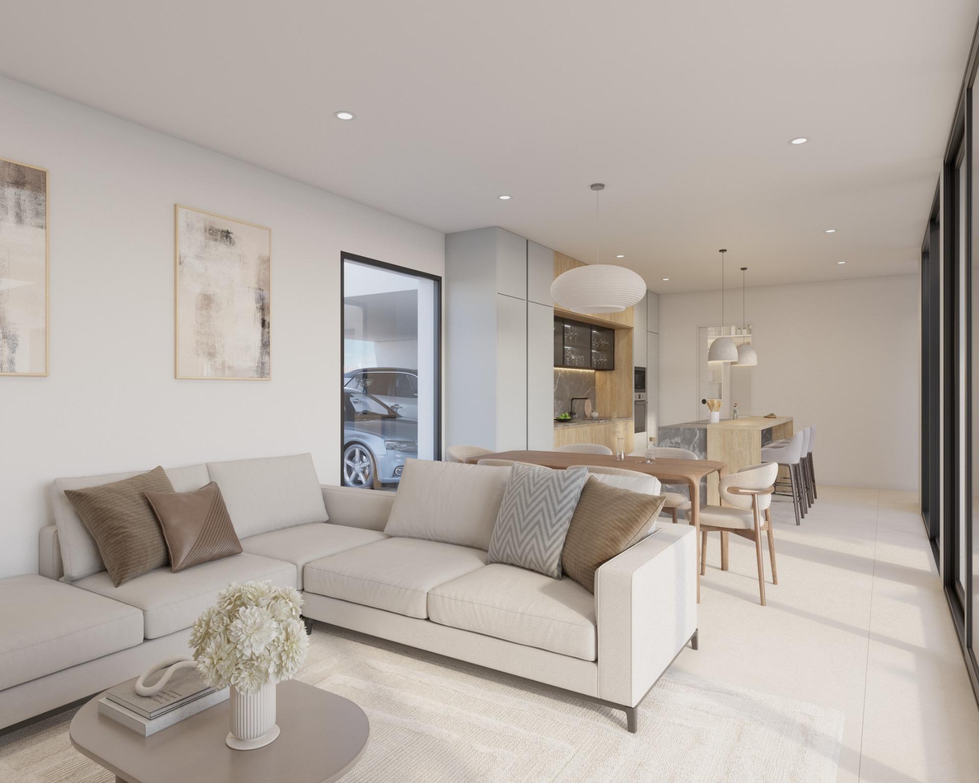 Neutral-toned living room view with wall-mounted TV, shelving and dining table behind