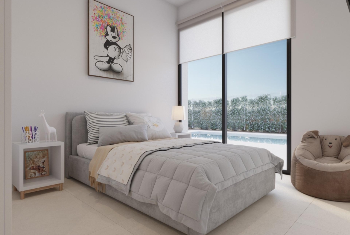 Guest bedroom with bed, bedside table and sliding doors opening to the pool area