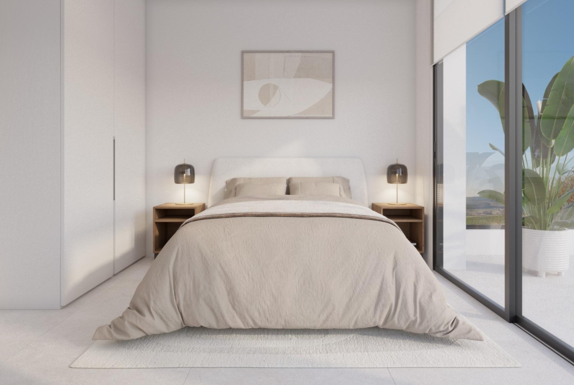 Bedroom corner with bed, shelving above and a chair beside window with blind