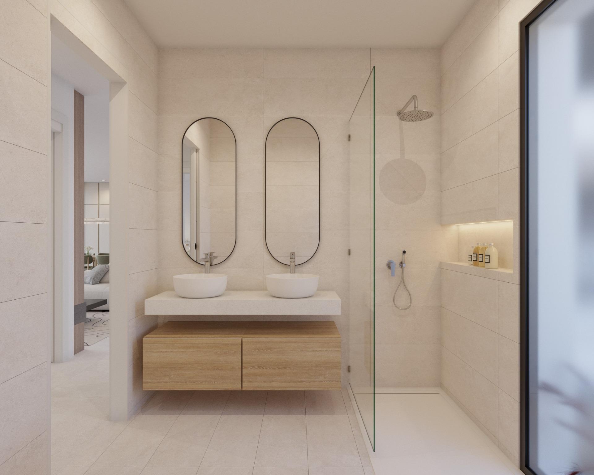 Neutral-toned bathroom with two oval mirrors, countertop basins and rain shower behind glass
