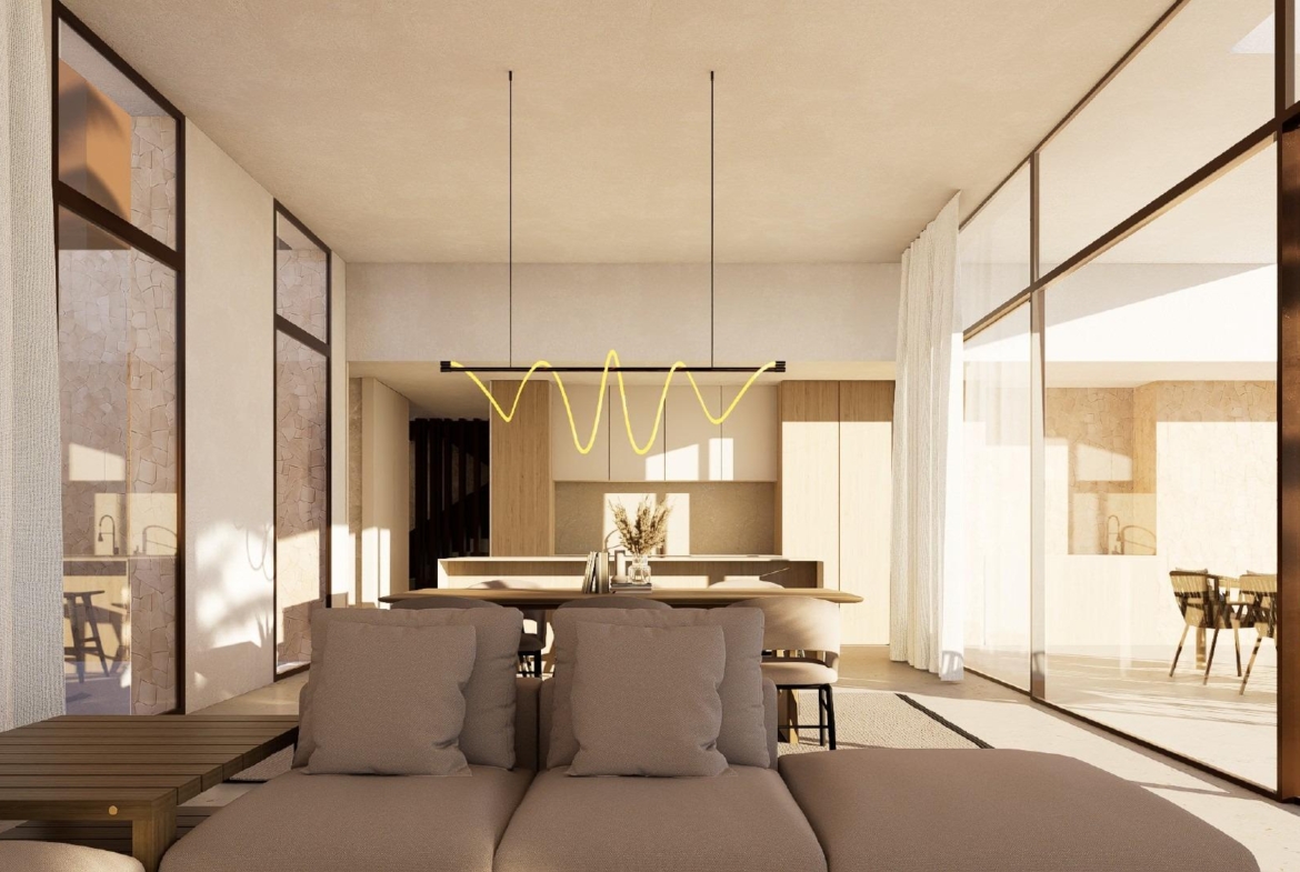 Open-plan living and dining area with pendant light, sofa and kitchen island visible