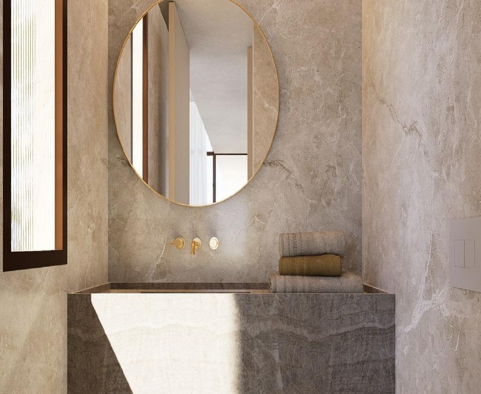 Dual-sink marble bathroom vanity with long mirror and corridor leading to bedroom