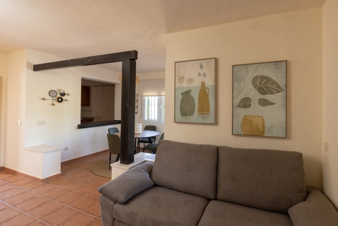 Sofa beside the dining area and kitchen serving hatch in Las Palas, Fuente Álamo, Murcia