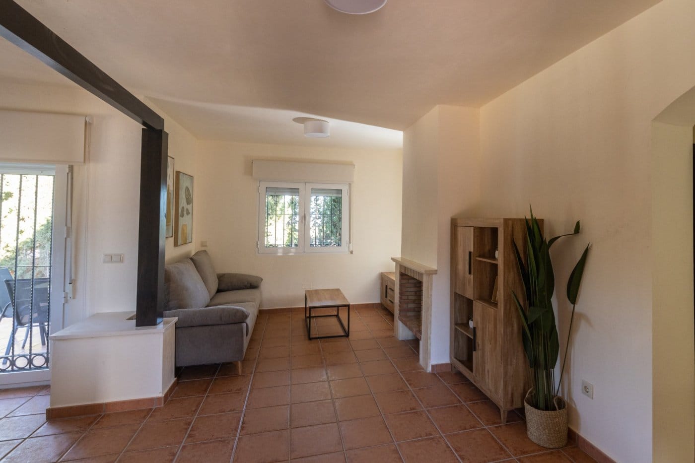 Living room with a fireplace and patio doors in Las Palas, Fuente Álamo, Murcia
