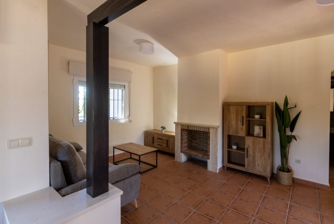 Fireplace and shelving beside the lounge seating in Las Palas, Fuente Álamo, Murcia
