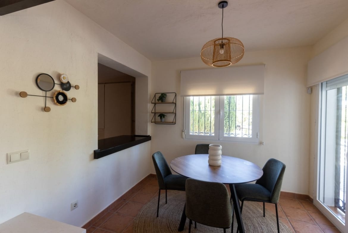 Dining table beside the kitchen serving hatch and window in Las Palas, Fuente Álamo, Murcia