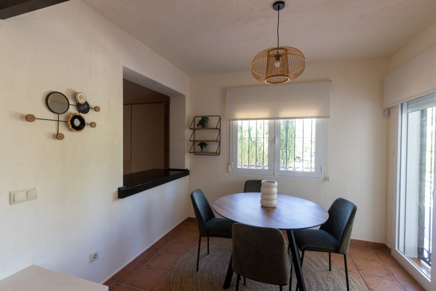 Dining table beside the kitchen serving hatch and window in Las Palas, Fuente Álamo, Murcia