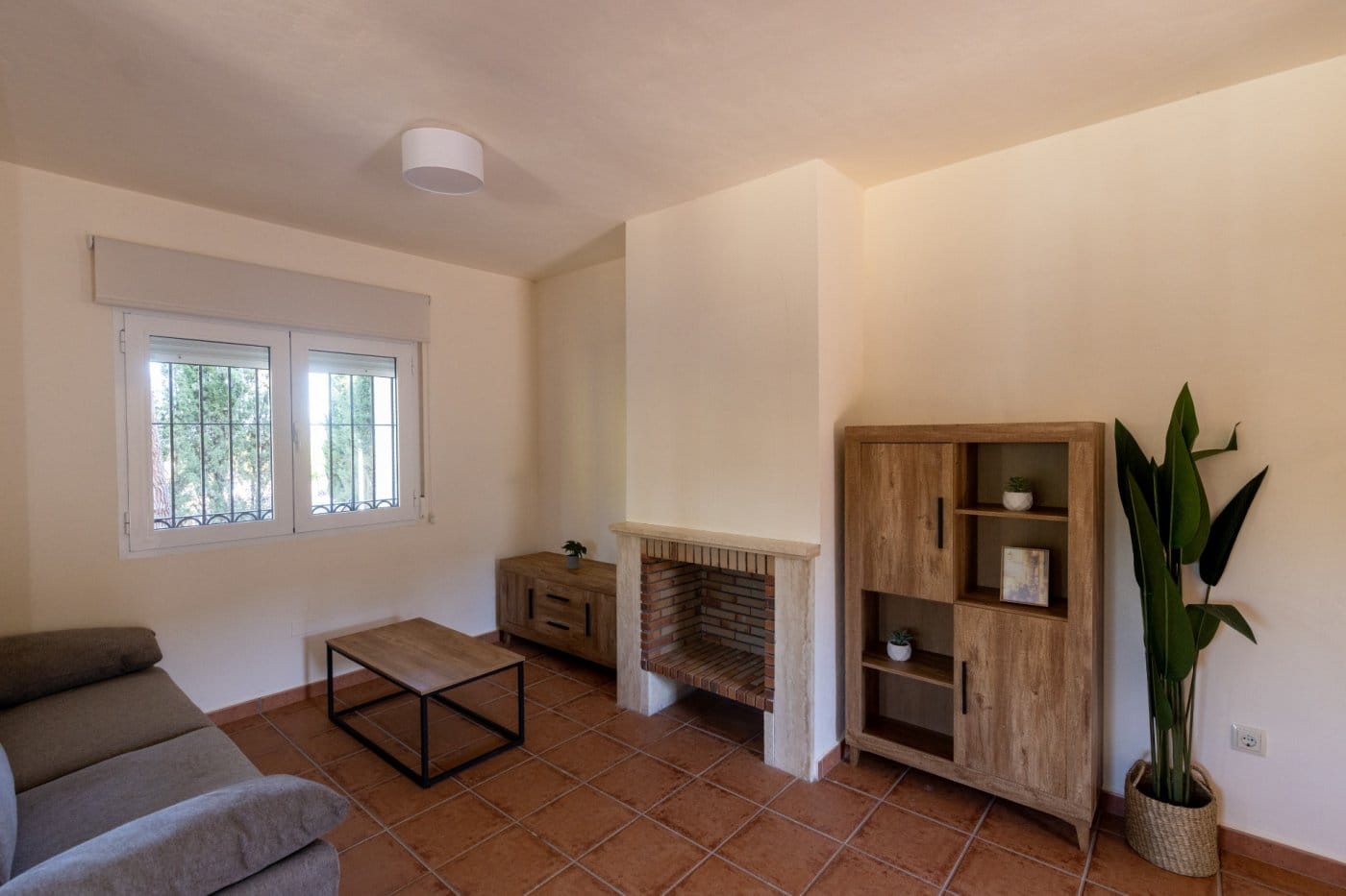 Sitting area beside a fireplace and wooden shelving in Las Palas, Fuente Álamo, Murcia
