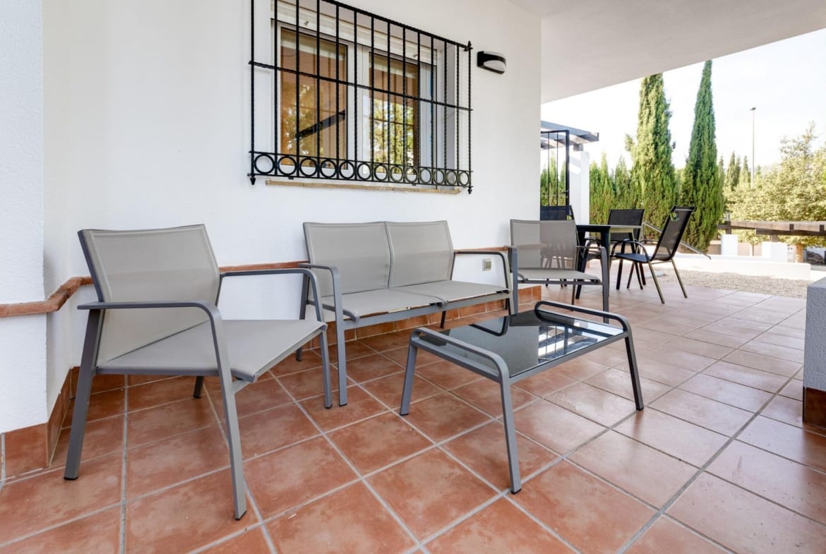 Covered porch with outdoor seating and a dining table in Las Palas, Fuente Álamo, Murcia