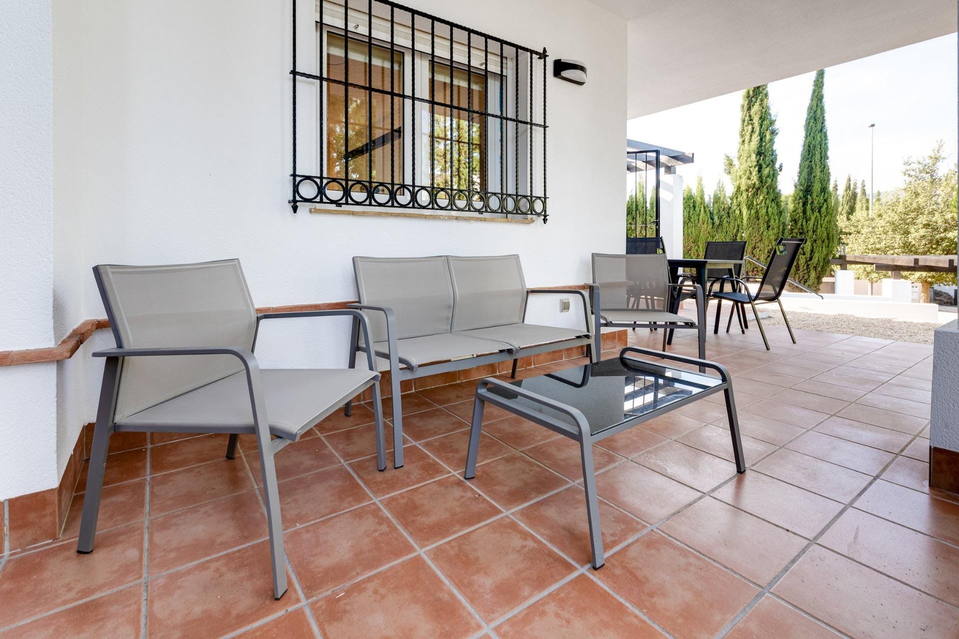 Covered porch with outdoor seating and a dining table in Las Palas, Fuente Álamo, Murcia