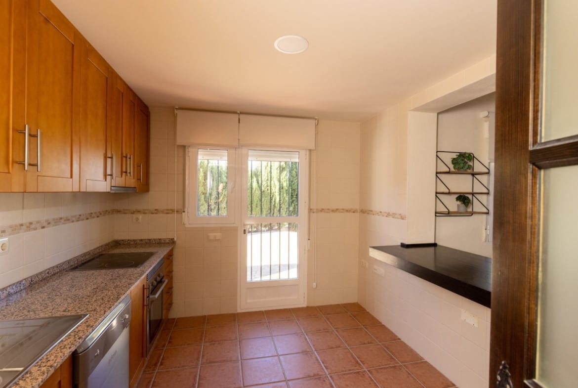 Kitchen with wood cabinets and a glazed door in Las Palas, Fuente Álamo, Murcia