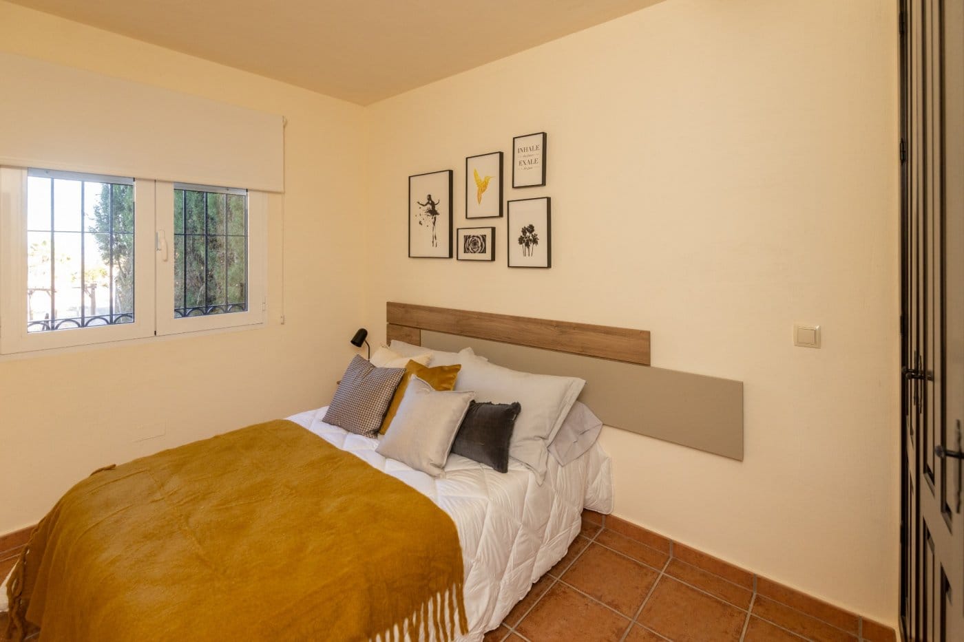Double bedroom with a wooden headboard and tiled floor in Las Palas, Fuente Álamo, Murcia