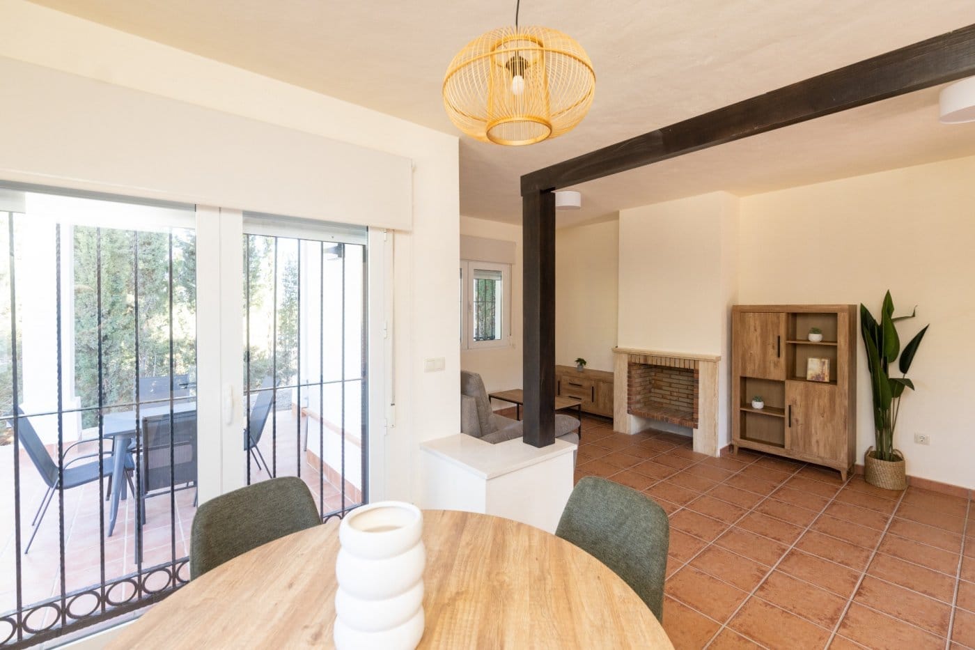 Dining area and fireplace beside glazed terrace doors in Las Palas, Fuente Álamo, Murcia