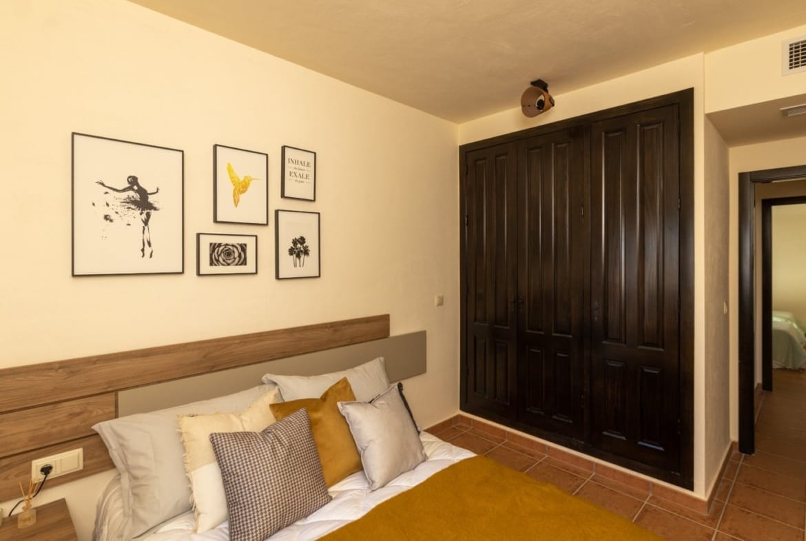 Double bedroom beside full-height wooden wardrobes in Las Palas, Fuente Álamo, Murcia