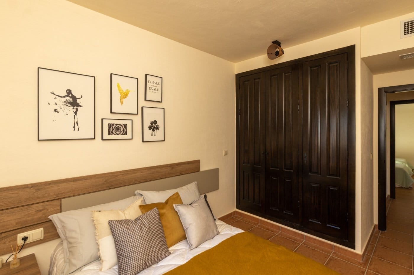 Double bedroom beside full-height wooden wardrobes in Las Palas, Fuente Álamo, Murcia