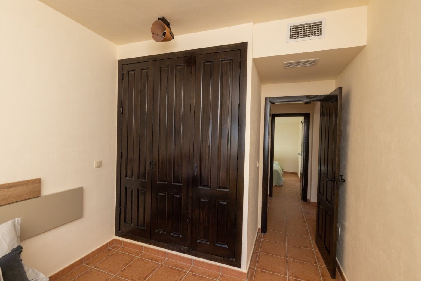 Dark fitted wardrobes and a doorway in a bedroom in Las Palas, Fuente Álamo, Murcia
