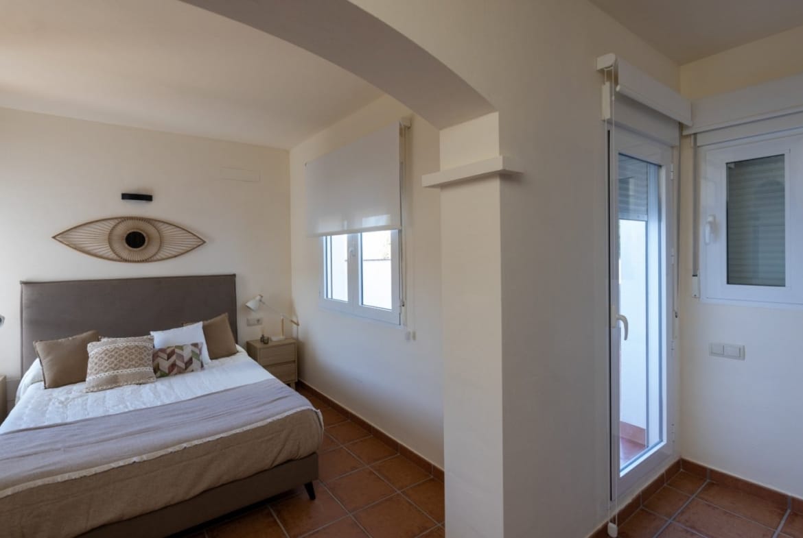 Double bedroom beside a glazed exterior door in Las Palas, Fuente Álamo, Murcia