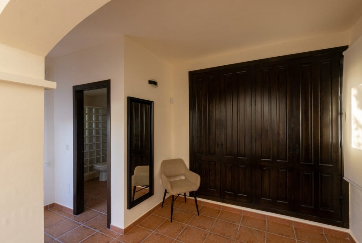 Bedroom dressing area with fitted wardrobes and a mirror in Las Palas, Fuente Álamo, Murcia