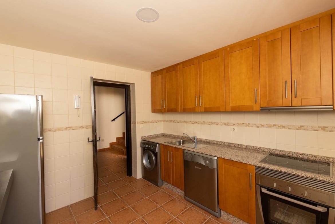Kitchen with wooden cabinets and tiled flooring in Las Palas, Fuente Álamo, Murcia