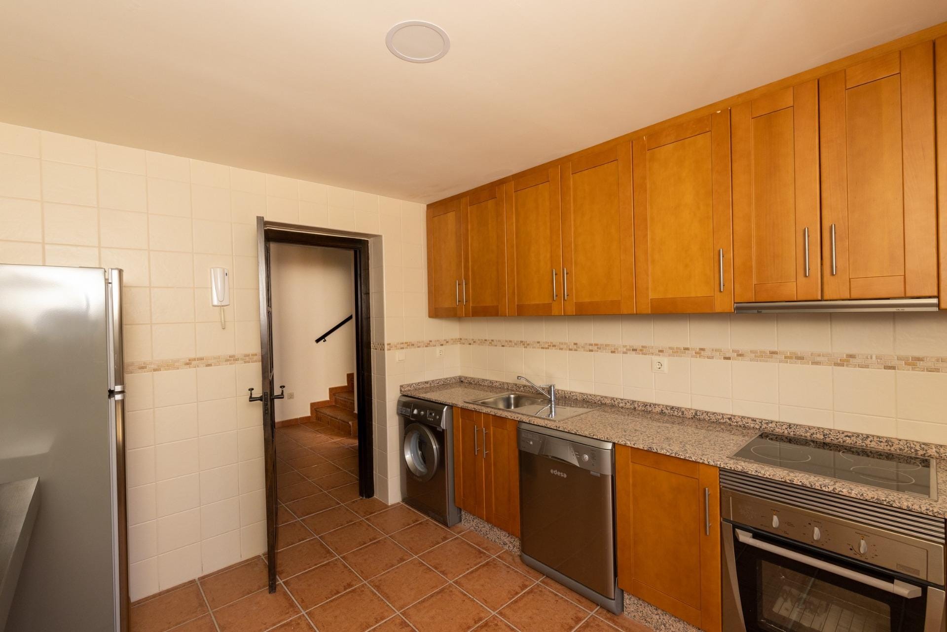 KEY-READY-TOWNHOUSES-IN-FUENTE-ALAMO-MURCIA-11 Kitchen with wooden cabinets and tiled flooring in Las Palas, Fuente Álamo, Murcia