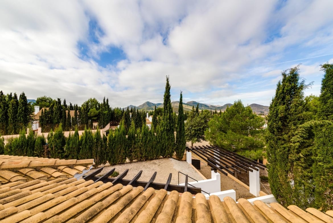 Tiled rooftops and pergola overlooking trees in Las Palas, Fuente Álamo, Murcia