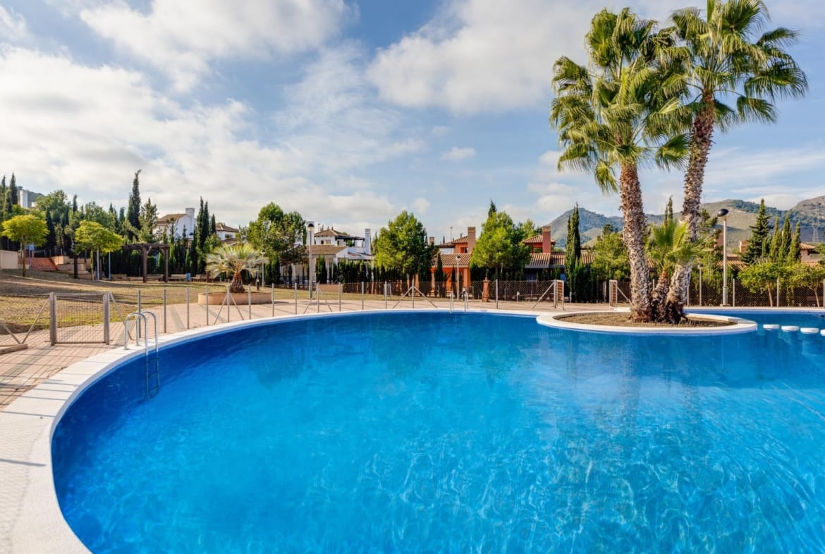 Communal swimming pool with a palm island and gardens in Las Palas, Fuente Álamo, Murcia