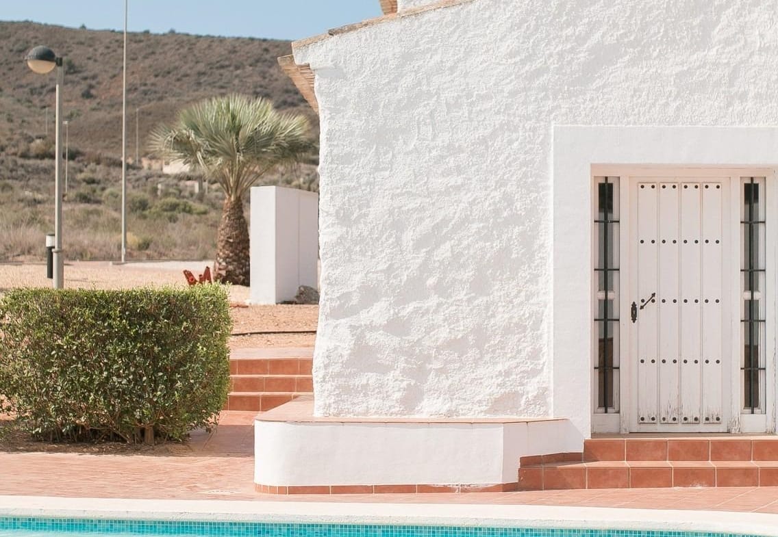Pool water beside a white building and hillside backdrop in Las Palas, Fuente Álamo, Murcia