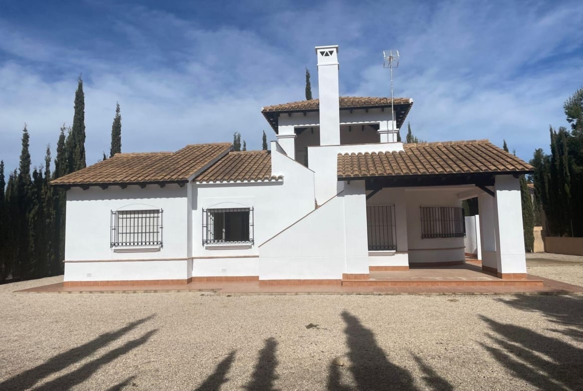 White villa facade with a covered porch and exterior roof stairs in Las Palas, Fuente Álamo, Murcia