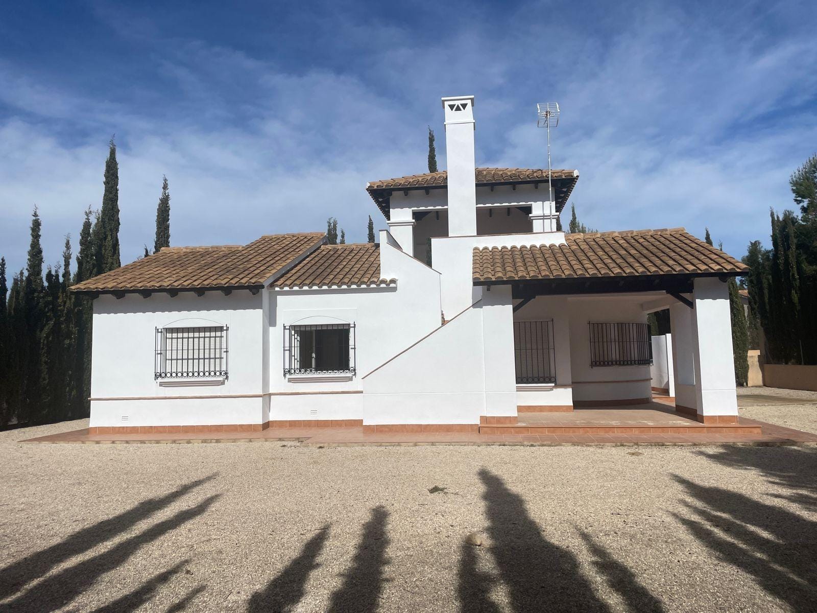 MURCIA White villa facade with a covered porch and exterior roof stairs in Las Palas, Fuente Álamo, Murcia