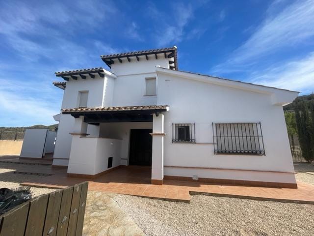 Villa entrance beneath a tiled porch and upper-floor terrace in Las Palas, Fuente Álamo, Murcia