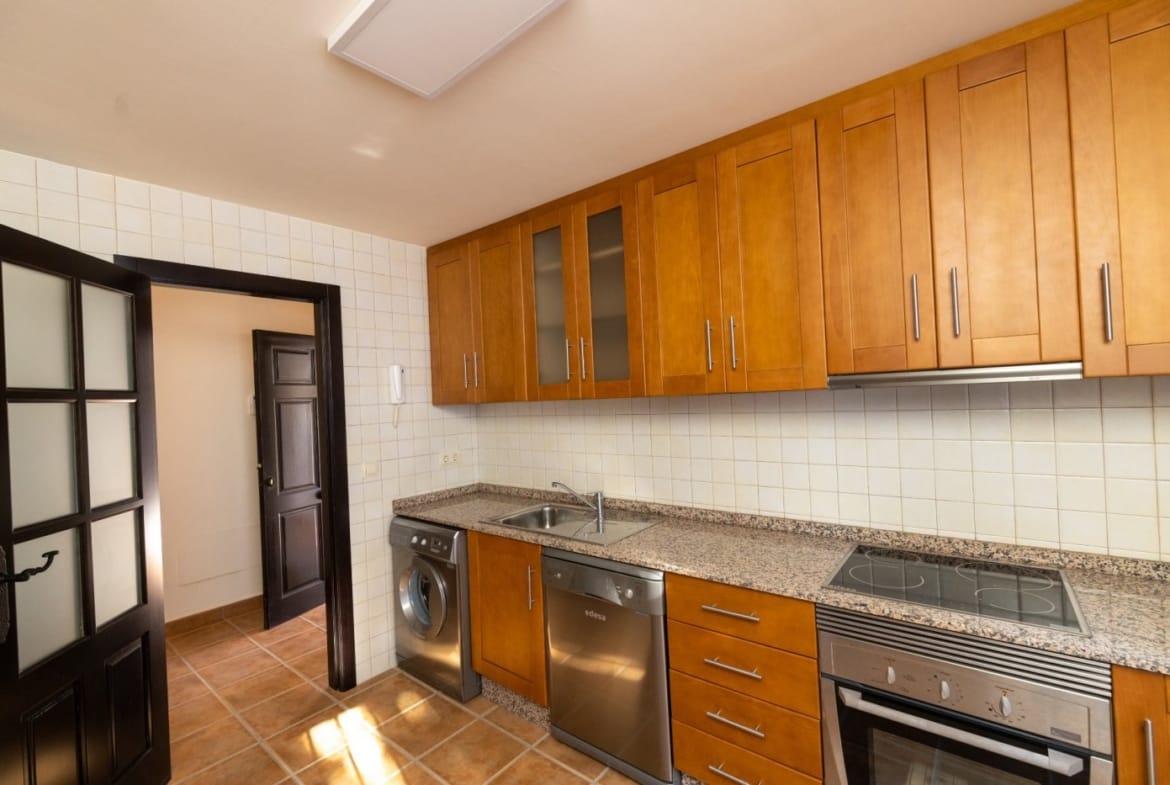 Wooden kitchen cabinets beside a glazed exterior door in Las Palas, Fuente Álamo, Murcia