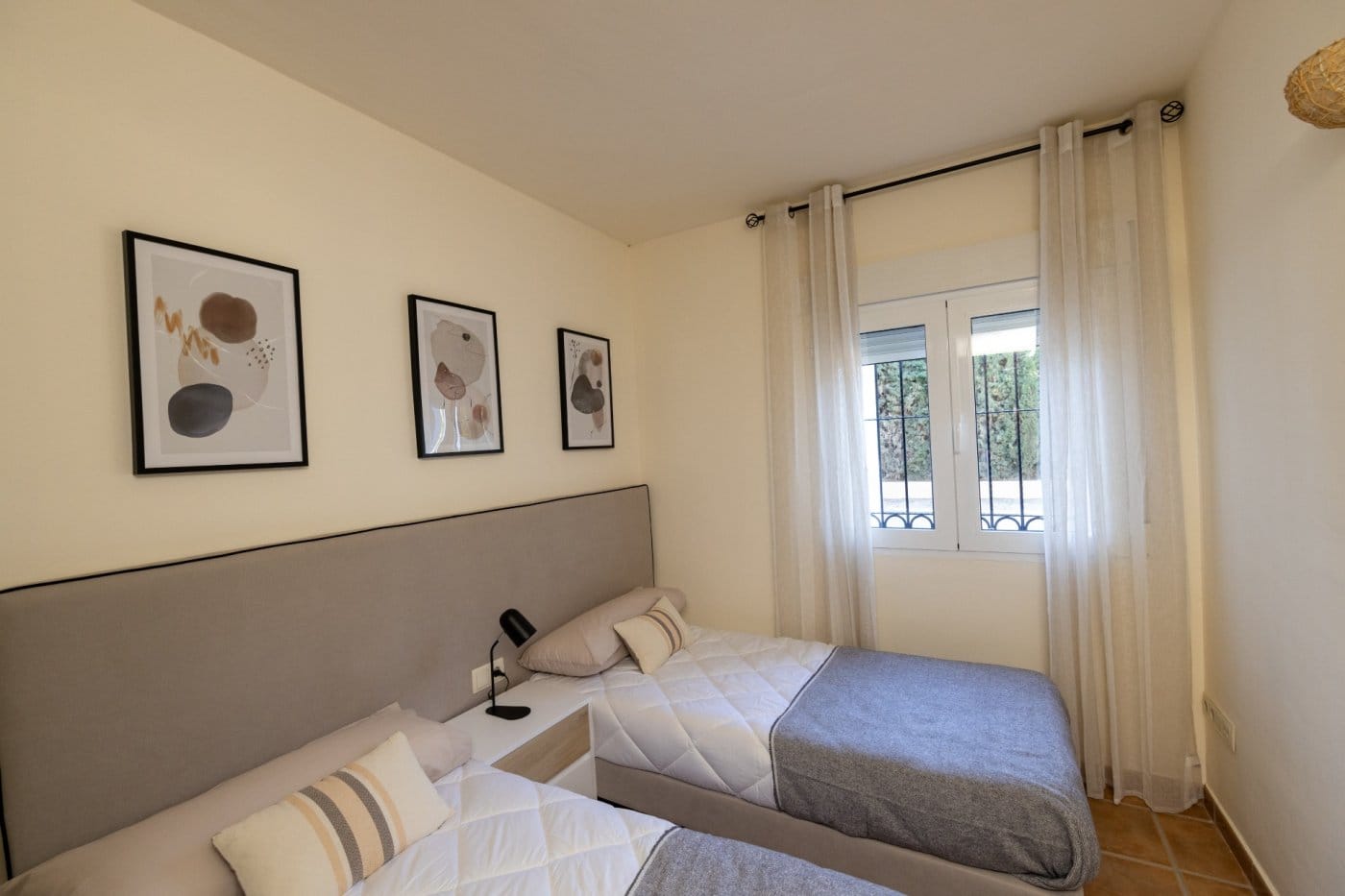 KEY-READY-VILLA-IN-FUENTE-ALAMO-MURCIA-21 Twin bedroom with a wide upholstered headboard and window in Las Palas, Fuente Álamo, Murcia