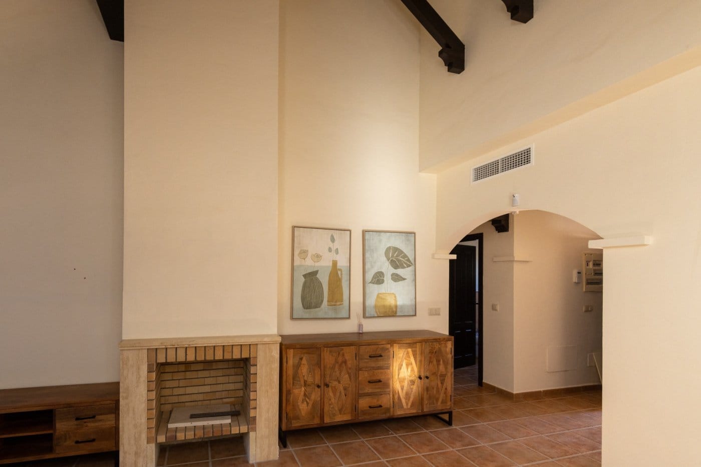 KEY-READY-VILLA-IN-FUENTE-ALAMO-MURCIA-26 Fireplace and wooden sideboard beside an arched doorway in Las Palas, Fuente Álamo, Murcia