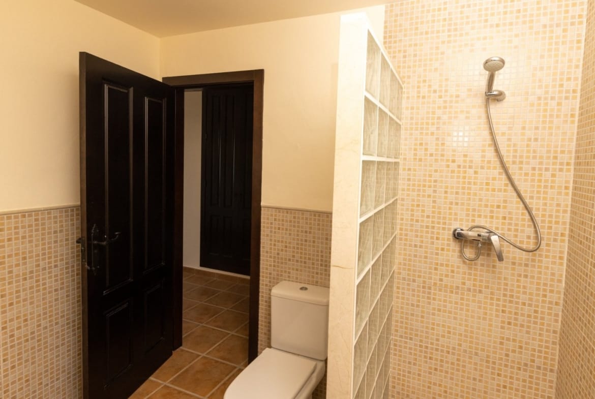 Tiled shower with a glass-block screen beside a doorway in Las Palas, Fuente Álamo, Murcia